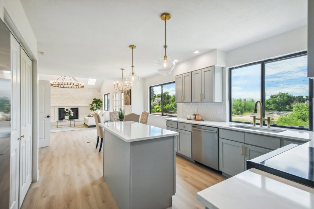 Full kitchen remodel in Centennial with light gray shaker cabinets, quartz countertops and custom tile backsplash