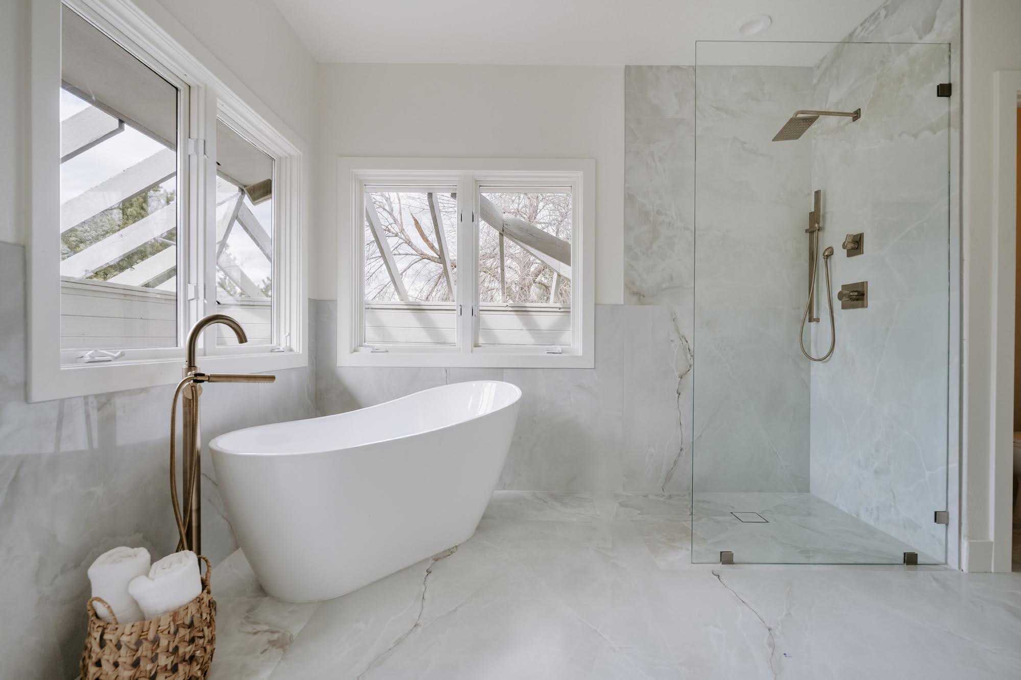 Luxury bathroom remodel in Colorado Springs with curbless walk in shower, freestanding soaking tub and large format tile