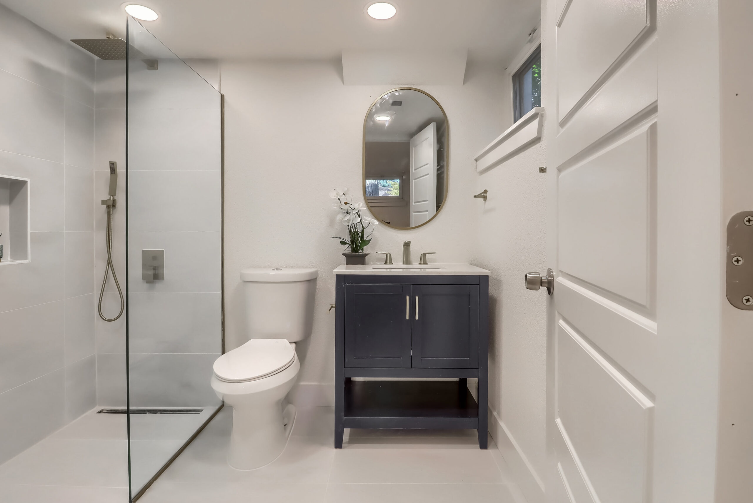 Full bathroom remodel in Denver with curbless walk in shower, glass enclosure and modern vanity