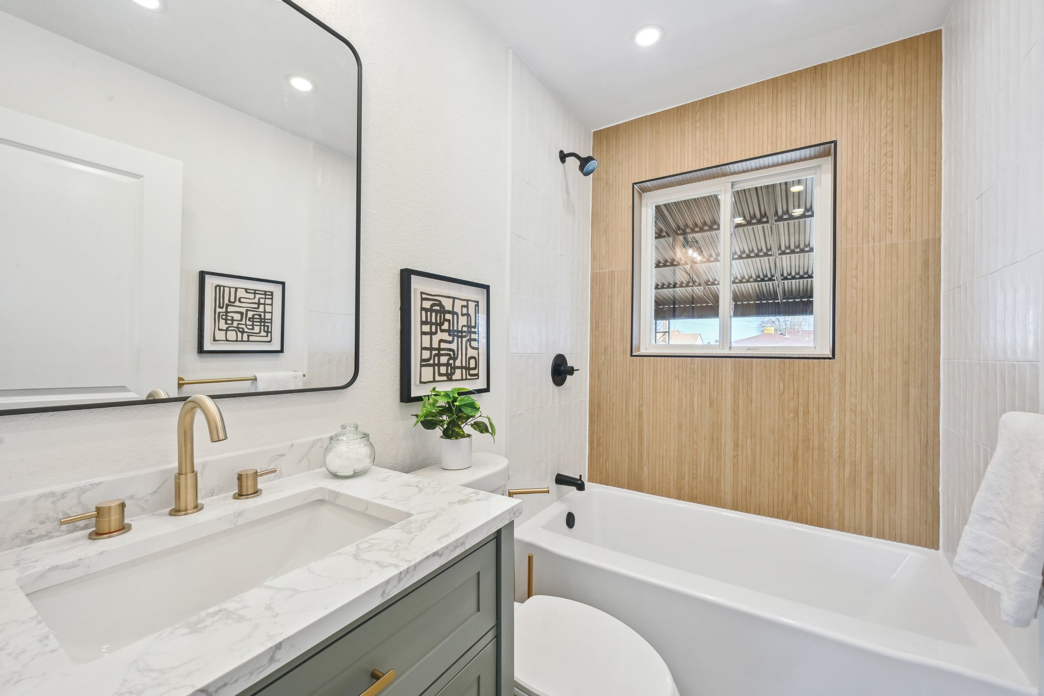 Bathroom remodel in Denver with sage vanity, zellige tile shower and matte black fixtures