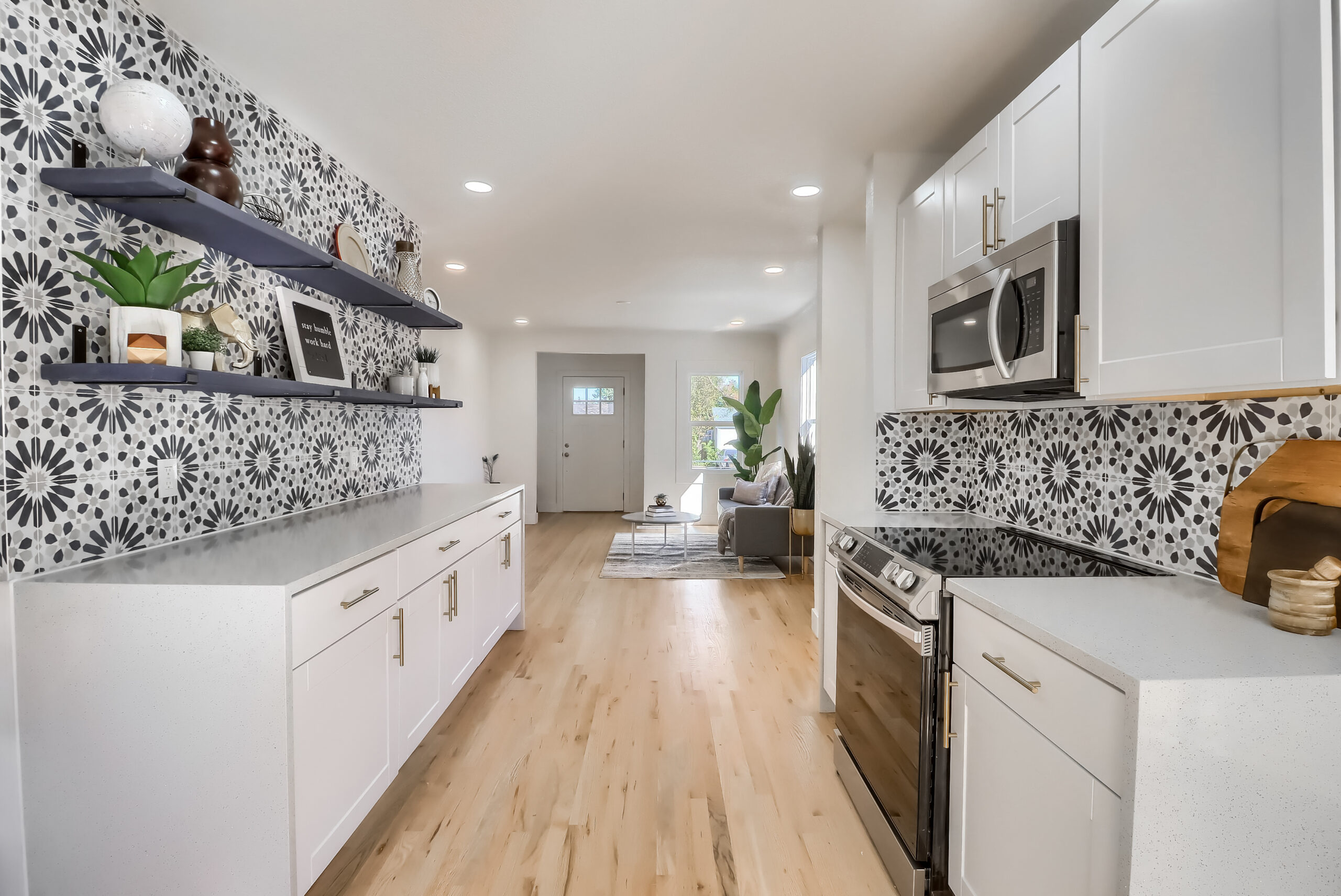 Full kitchen remodel in Denver with white shaker cabinets, Spanish patterned tile backsplash and quartz countertops